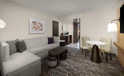 a living room with a couch and a table at Embassy Suites by Hilton Cincinnati Northeast - Blue Ash in Blue Ash