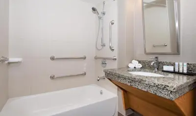a bathroom with a sink and a shower and a tub at Embassy Suites by Hilton Cincinnati Northeast - Blue Ash in Blue Ash