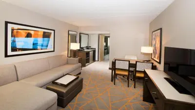 a large living room with a couch and a desk at Embassy Suites by Hilton Cincinnati Northeast - Blue Ash in Blue Ash