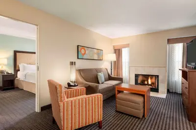 a hotel room with a couch and a fireplace at Homewood Suites by Hilton Columbus-Hilliard in Hilliard