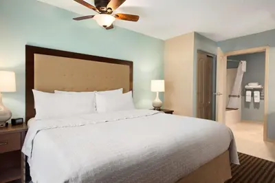 a bedroom with a white bed and a ceiling fan at Homewood Suites by Hilton Columbus-Hilliard in Hilliard