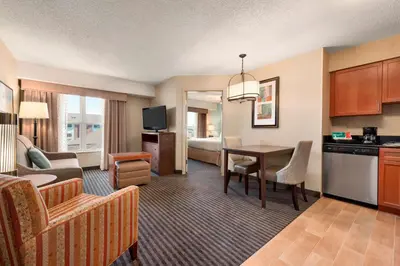 a living room with a kitchen and a dining room at Homewood Suites by Hilton Columbus-Hilliard in Hilliard