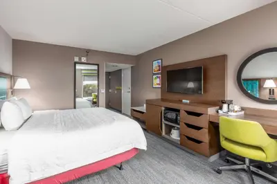 a hotel room with a bed and a desk and a television at Hampton Inn Columbus/Dublin in Dublin