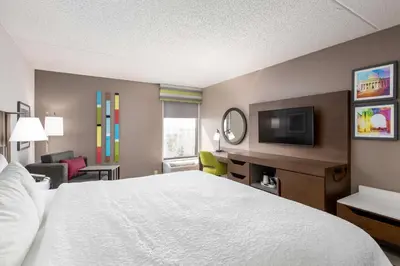 a hotel room with a bed and a flat screen tv at Hampton Inn Columbus/Dublin in Dublin