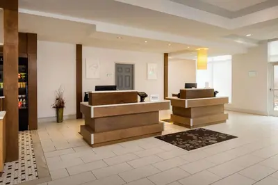 a lobby with two reception desks in a building at Hilton Garden Inn Cincinnati Blue Ash in Blue Ash