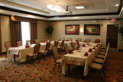 a conference room with tables and chairs in it at Hilton Garden Inn Cincinnati Blue Ash in Blue Ash