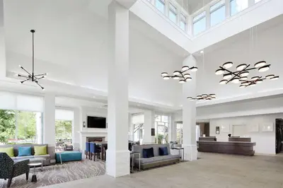 a large living room with white walls and ceilings at Hilton Garden Inn Cincinnati Northeast in Loveland