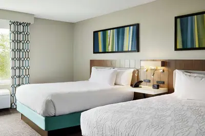a hotel room with two beds and a phone at Hilton Garden Inn Cincinnati Northeast in Loveland