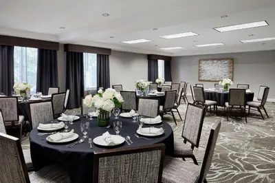 a conference room with tables and chairs and flowers at Hilton Garden Inn Cincinnati Northeast in Loveland
