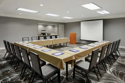 a conference room with a long table and chairs at Hilton Garden Inn Cincinnati Northeast in Loveland