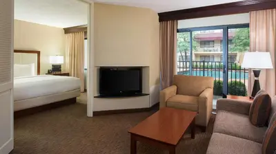 a hotel room with a bed and a television at DoubleTree Suites by Hilton Hotel Cincinnati - Blue Ash in Sharonville