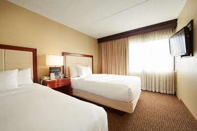 a hotel room with two beds and a window at DoubleTree Suites by Hilton Hotel Cincinnati - Blue Ash in Sharonville