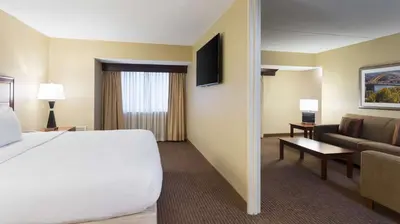 a hotel room with a bed and a couch at DoubleTree Suites by Hilton Hotel Cincinnati - Blue Ash in Sharonville