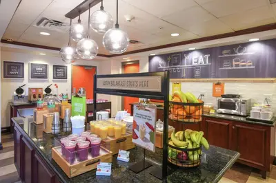 a bakery with a counter with bananas in baskets at Hampton Inn & Suites Cincinnati-Union Centre in West Chester