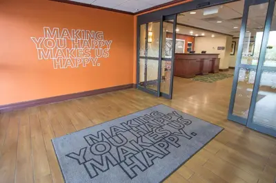 a room with a sign that says making you happy makes us happy at Hampton Inn & Suites Cincinnati-Union Centre in West Chester