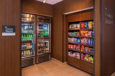 a grocery store aisle with two refrigerators and drinks at Fairfield Inn & Suites by Marriott Huntington in Huntington