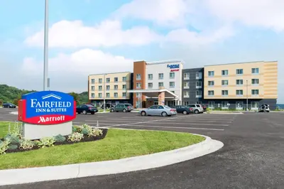 a sign in a parking lot in front of a hotel at Fairfield Inn & Suites by Marriott Huntington in Huntington