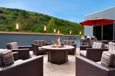 a patio with a table and chairs and an umbrella at TownePlace Suites by Marriott Pittsburgh Airport/Robinson Township in Robinson Township