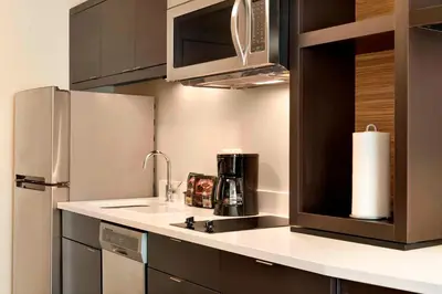a kitchen with a sink and a refrigerator at TownePlace Suites by Marriott Pittsburgh Airport/Robinson Township in Robinson Township