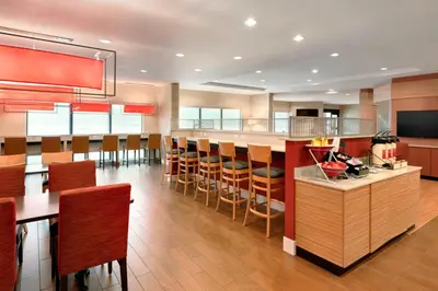 a kitchen with a bar with wooden stools at TownePlace Suites by Marriott Pittsburgh Airport/Robinson Township in Robinson Township