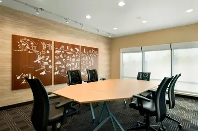 a conference room with a wooden table and chairs at TownePlace Suites by Marriott Pittsburgh Airport/Robinson Township in Robinson Township