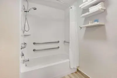 a bathroom with a shower and a white tub at Hampton Inn Columbus/Delaware I-71 North in Sunbury