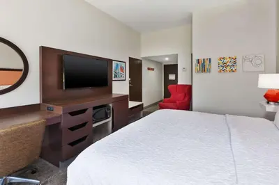 a hotel room with a bed and a flat screen tv at Hampton Inn Columbus/Delaware I-71 North in Sunbury