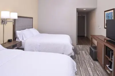 a hotel room with two beds and a flat screen tv at Hampton Inn & Suites Cincinnati-Mason, Ohio in Mason