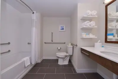 a bathroom with a toilet and a tub and a sink at Hampton Inn & Suites Cincinnati-Mason, Ohio in Mason