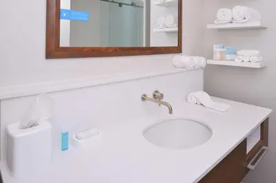 a bathroom with a white sink and a mirror at Hampton Inn & Suites Cincinnati-Mason, Ohio in Mason