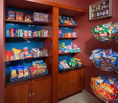 a snack pantry with shelves of chips and snacks at Hampton Inn & Suites Pittsburgh-Meadow Lands in Washington
