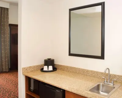 a bathroom with a sink and a mirror at Hampton Inn & Suites Pittsburgh-Meadow Lands in Washington