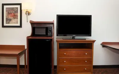 a television on a wooden stand with a microwave at Hampton Inn & Suites Pittsburgh-Meadow Lands in Washington