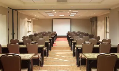 an empty room with rows of tables and chairs at Hampton Inn & Suites Pittsburgh-Meadow Lands in Washington