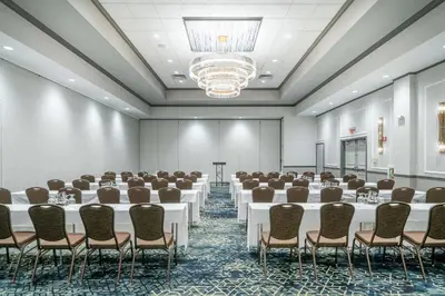 a conference room with tables and chairs and a chandelier at Hilton Garden Inn Pittsburgh/Southpointe in Canonsburg