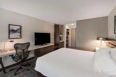 a hotel room with a bed and a desk with a computer at Hilton Garden Inn Columbus/Grove City in Grove City