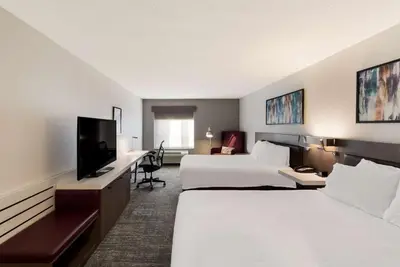 a hotel room with two beds and a flat screen tv at Hilton Garden Inn Columbus/Grove City in Grove City