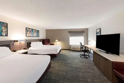 a hotel room with two beds and a flat screen tv at Hilton Garden Inn Columbus/Grove City in Grove City