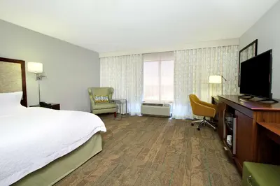 a hotel room with a bed and a flat screen tv at Hampton Inn & Suites Columbus Hilliard in Hilliard