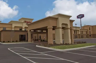 a building with a parking lot in front of it at Hampton Inn Columbus-South in Grove City