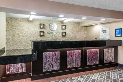 a lobby of a dental office with pink and purple doors at Comfort Inn Blue Ash North in Blue Ash