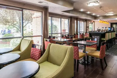 a restaurant with tables and chairs and a bar at Comfort Inn Blue Ash North in Blue Ash