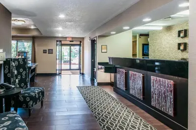 a restaurant with a bar with chairs and tables at Comfort Inn Blue Ash North in Blue Ash