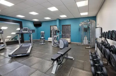 a gym with treadmills and machines in a room at Hampton Inn Cincinnati Northwest Fairfield in Fairfield