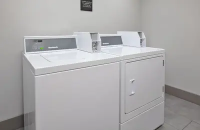 a washing machine and a sink in a room at Hampton Inn Cincinnati Northwest Fairfield in Fairfield