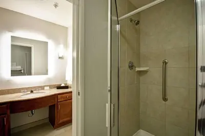 a bathroom with a shower and a sink at Homewood Suites by Hilton Cincinnati-Milford in Milford