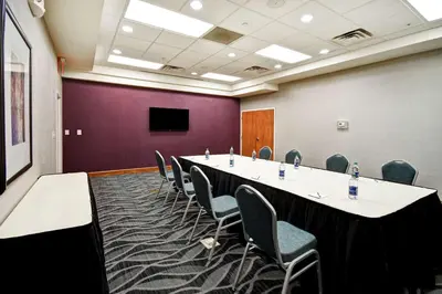 a conference room with a long table and chairs at Homewood Suites by Hilton Cincinnati-Milford in Milford