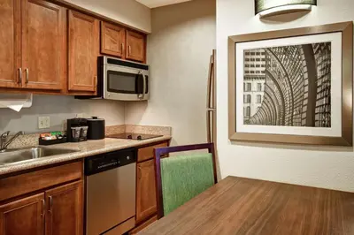 a small kitchen with a sink and a microwave at Homewood Suites by Hilton Cincinnati-Milford in Milford