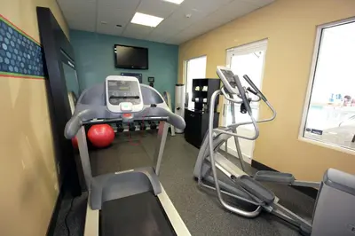 a room with a gym with a treadmill and a phone at Hampton Inn Sandusky-Central in Sandusky