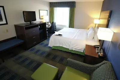 a hotel room with a bed and a television at Hampton Inn Sandusky-Central in Sandusky
